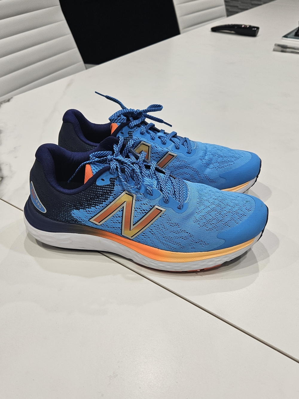 New Balance Men's Fresh Foam 680 Blue Running Shoes with Orange Accent